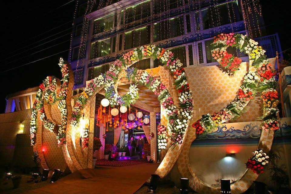 Stunning night view of a luxury wedding venue at EllBee Ganga View, Rishikesh, adorned with vibrant floral decorations and elegant lighting